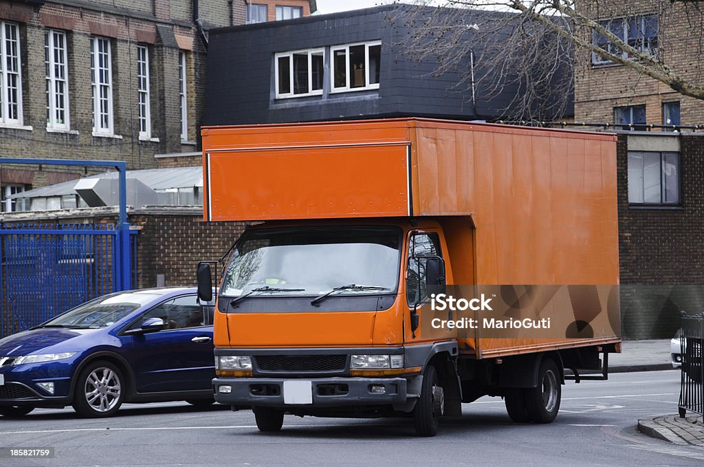 Delivery service truck An orange delivery truck in a street in London, United Kingdom. Advertisement Stock Photo