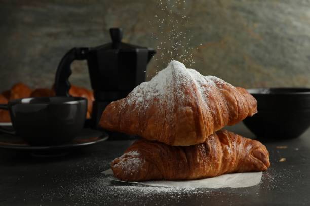 istock Dusting powdered sugar onto delicious fresh croissants at grey table 1858217921