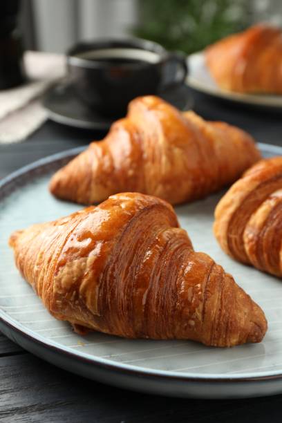 istock Delicious fresh croissants on dark table indoors, closeup 1858218448