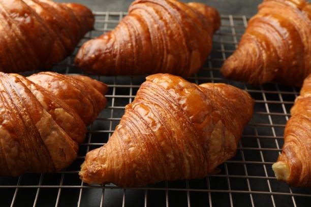 istock Delicious fresh croissants on grey table, closeup 1858218909