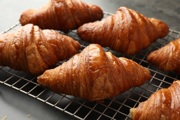 istock Delicious fresh croissants on grey table, closeup 1858218951