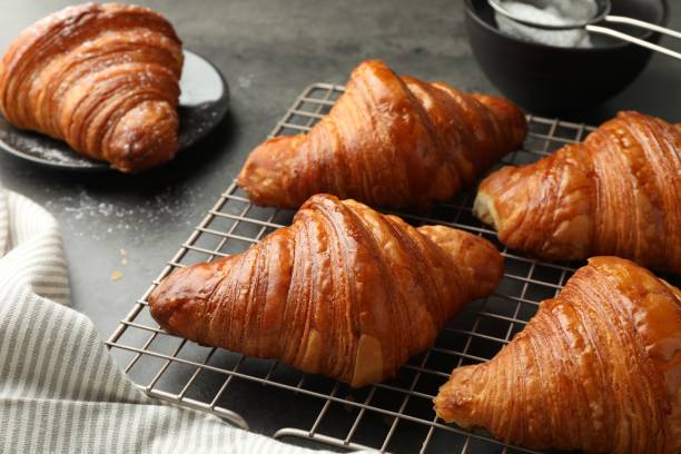 istock Delicious freshly baked croissants on grey table 1858218955