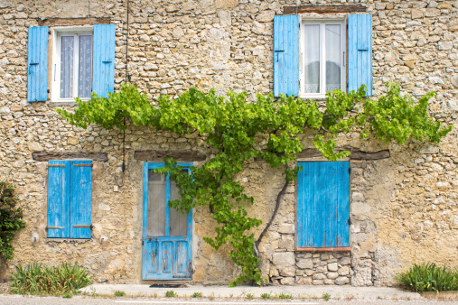 Blue colored window shutter on cottage in Provence. France.