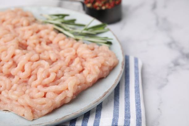 istock Fresh raw minced meat on white marble table, closeup. Space for text 1858246138