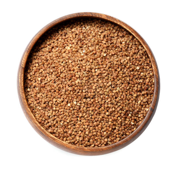 istock Bowl with dry buckwheat isolated on white, top view 1858247707