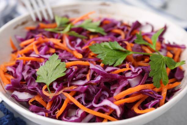 istock Tasty salad with red cabbage in bowl on table, closeup 1858257906