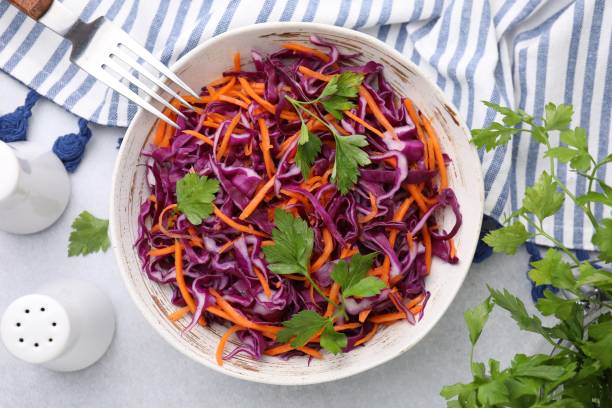 istock Eating tasty salad with red cabbage on light table, flat lay 1858258409