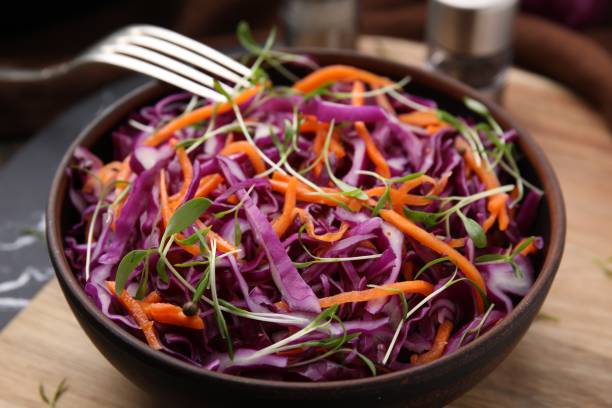 istock Eating tasty salad with red cabbage at table, closeup 1858258769