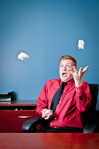 Employee goofing off in his office and juggling stock photo