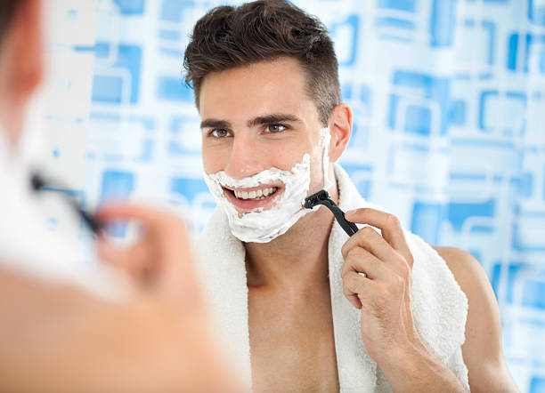 istock Happy laughing man shaving his face 185826821