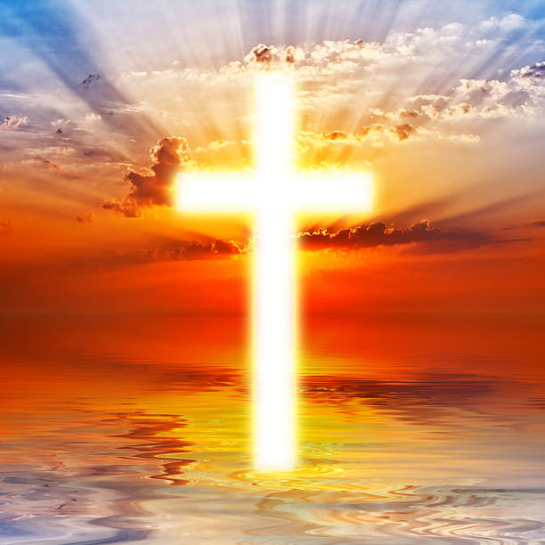 istock Cross appearing on sunrise sky 185828943