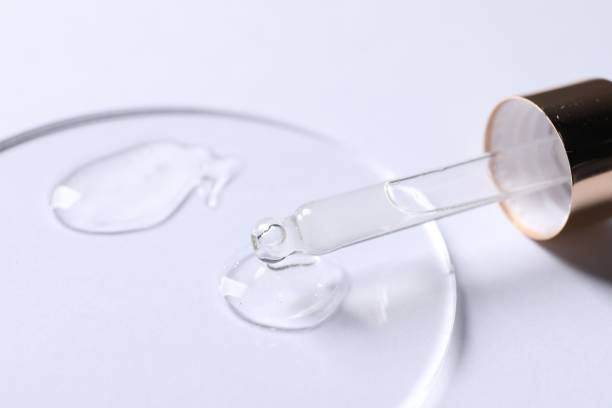 istock Samples of cosmetic serum and pipette on white background, closeup 1858328254