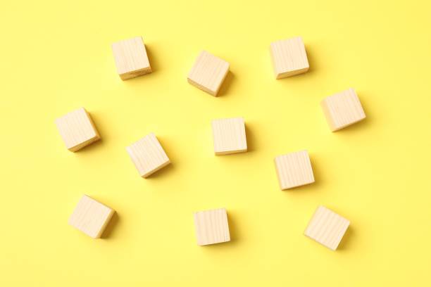istock Many empty wooden cubes on yellow background, flat lay 1858337465