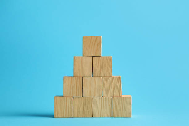 istock Pyramid of blank wooden cubes on light blue background 1858337983