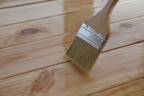 istock Varnishing wooden surface with brush, closeup view 1858338500