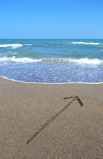 istock Sand Drawn Arrow to the Sea 185835733