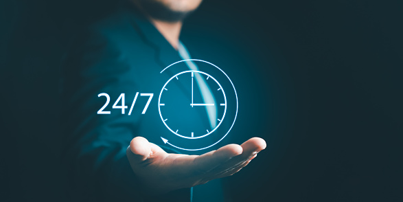 Businessman or Manager Customer Service show hand holding virtual 24-7 with clock for worldwide nonstop and full-time available contact Online consultation 24 hours a day nonstop service.