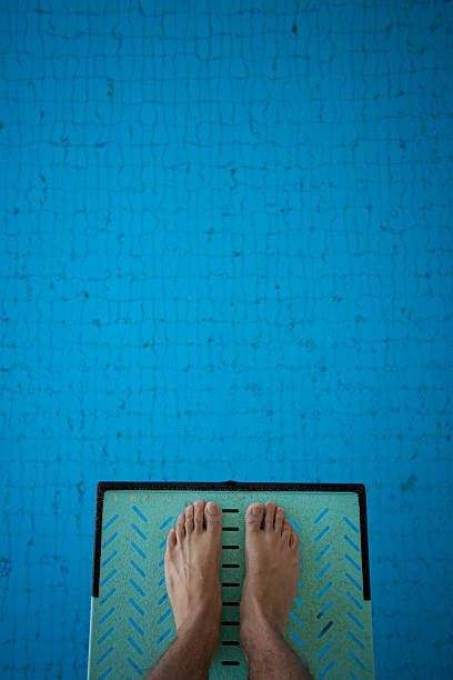 feet on diving board stock photo