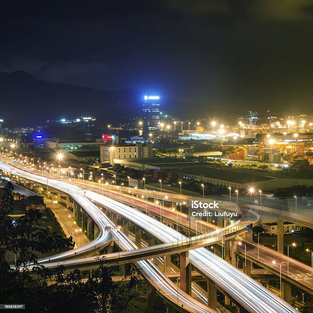 Overpass bridge and pier in night Freeway in night with cars light in modern city Bridge - Built Structure Stock Photo