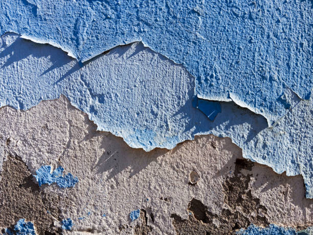 istock Abstract grunge background. Weathered old cement wall with 
peeling blue paint. Aged damaged  flaking cement wall with copy space. Abstract wallpaper 1858403866