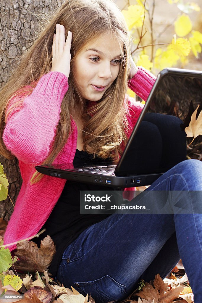 girl with laptop in autumn park Pretty girl in autumn park with laptop Adult Student Stock Photo
