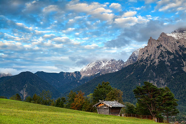 istock hut on meadow and Karwendel mountain range by Mittenwald 185840456