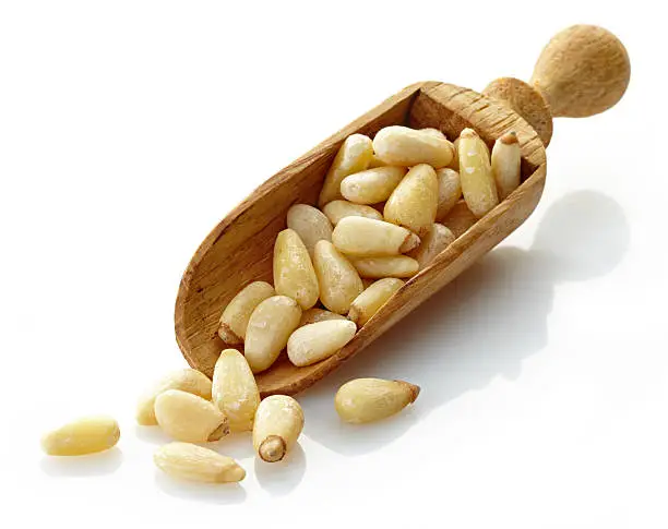 wooden scoop with pine nuts