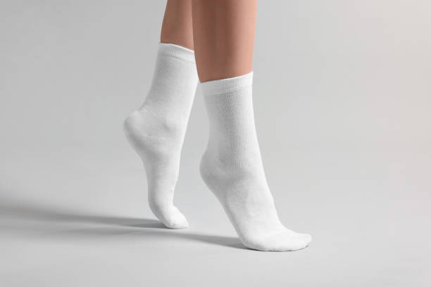 istock Woman in stylish white socks on light grey background, closeup 1858414199