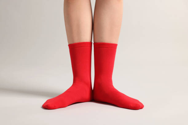 istock Woman in stylish red socks on light grey background, closeup 1858414200