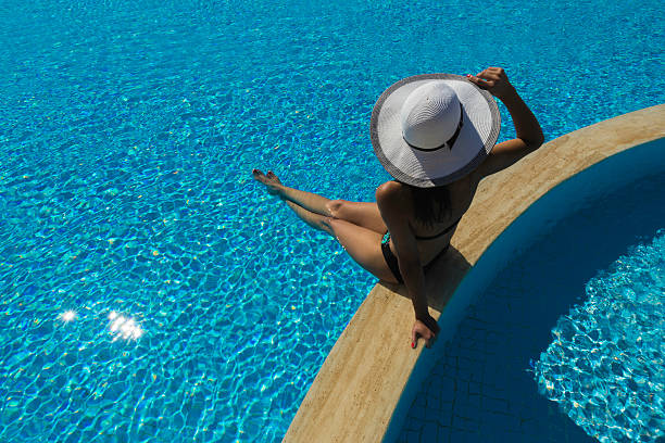 istock Girl in white hat by pool 185843819
