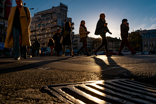 Bucharest, Romania - November 14, 2023: People cross the street in Bucharest, Romania. This image is for editorial use only.