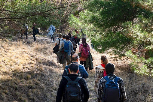 Ankara, Turkey - December 02, 2023: People who love nature sports walk in nature with their backpacks.