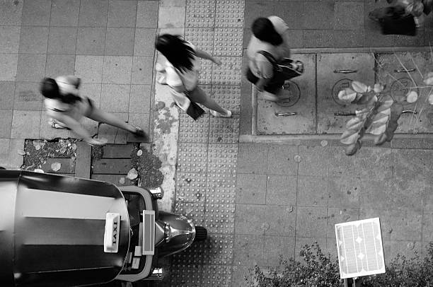 People on pedestrian walkway and Thai taxi
