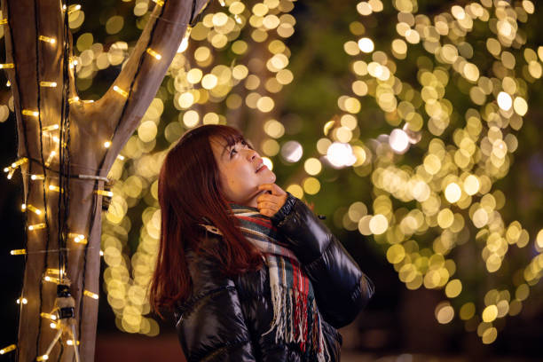 Happy young woman looking at Christmas lights