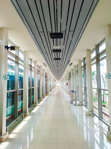 Jakarta, Indonesia - 11-29-2023: A long corridor at Soekarno Hatta Airport Station. Empty room. Perspective photography.