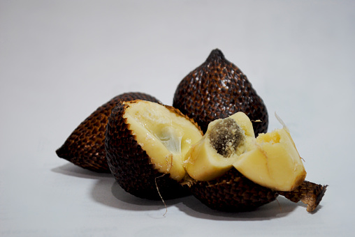 Snake fruit, also known as salak, is a rare species of palm tree native to Indonesia. The fruit is named for the scaley outer skin of the fig-shaped fruit
