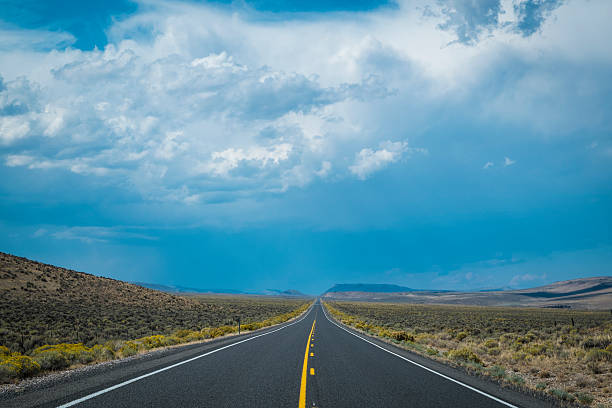 istock Dark storm clouds above desert highway 185853072