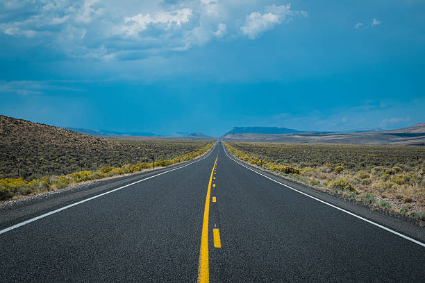 istock Dark storm clouds above desert highway 185853087