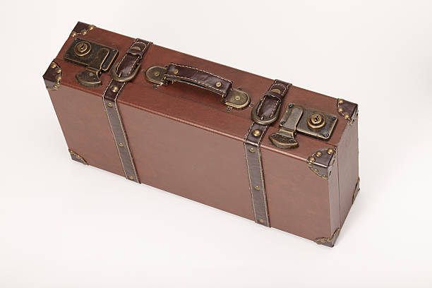 istock Old vintage leather suitcase standing isolated on white 185853278