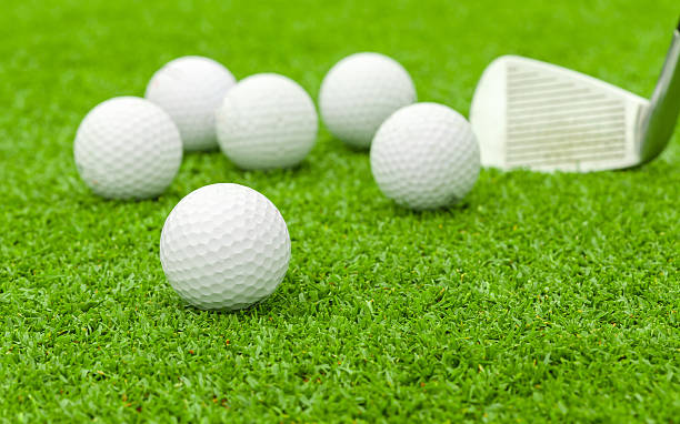 istock golf ball on tee in front of driver green course 185853948