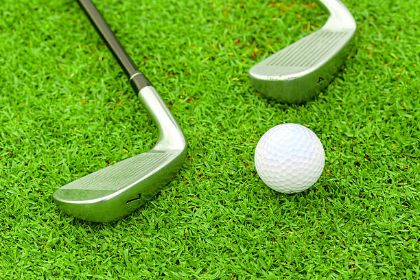 istock golf ball on tee in front of driver green course 185853956