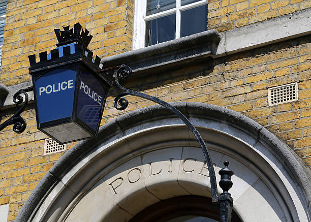 London - Police Sign A Police sign above the doorway to a police station in London, United Kingdom police station stock pictures, royalty-free photos & images