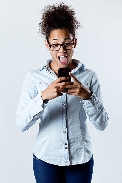 istock Surprised black woman looking the mobile 185855932