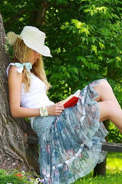 istock Beautiful girl reading a book 185858956