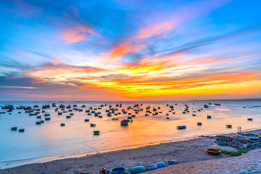 Mui Ne fishing village in sunset sky with hundreds of boats anchored to avoid storms, this is a beautiful bay in central Vietnam