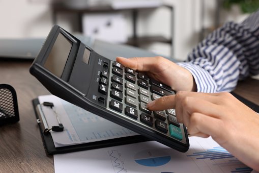 Businessman using calculator