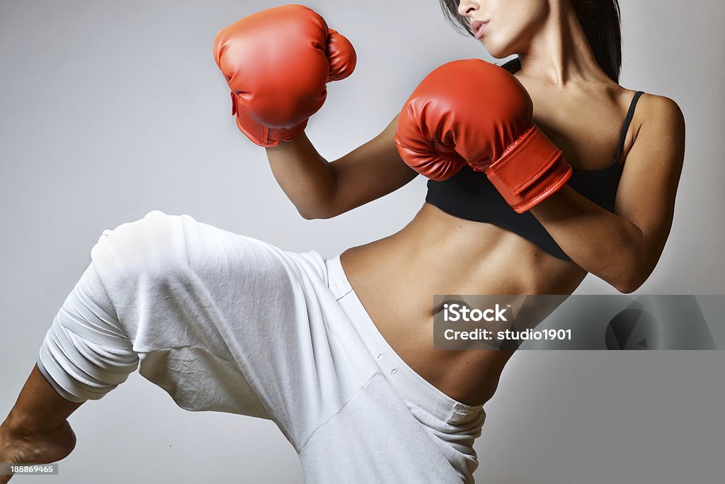 beautiful woman boxing beautiful woman with the red boxing gloves, studio shot Kickboxing Stock Photo