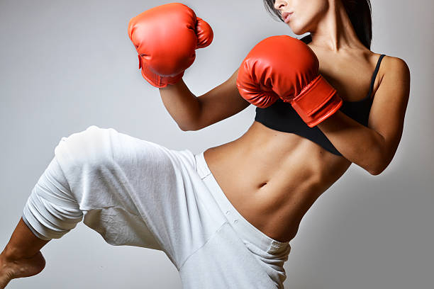 beautiful woman boxing beautiful woman with the red boxing gloves, studio shot kickboxing photos stock pictures, royalty-free photos & images