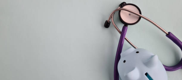 istock Piggy bank with stethoscope on blue background with copy space 1858709315
