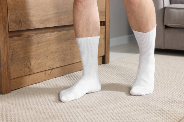 istock Man in stylish white socks indoors, closeup 1858715133